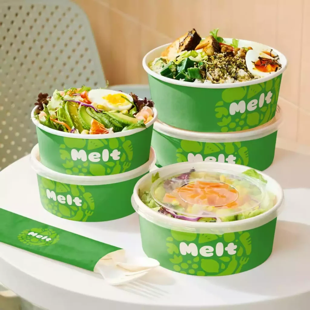 Eco-friendly custom wide paper bowls filled with fresh salads, showcasing durable food packaging solutions for effective restaurant food cost control.