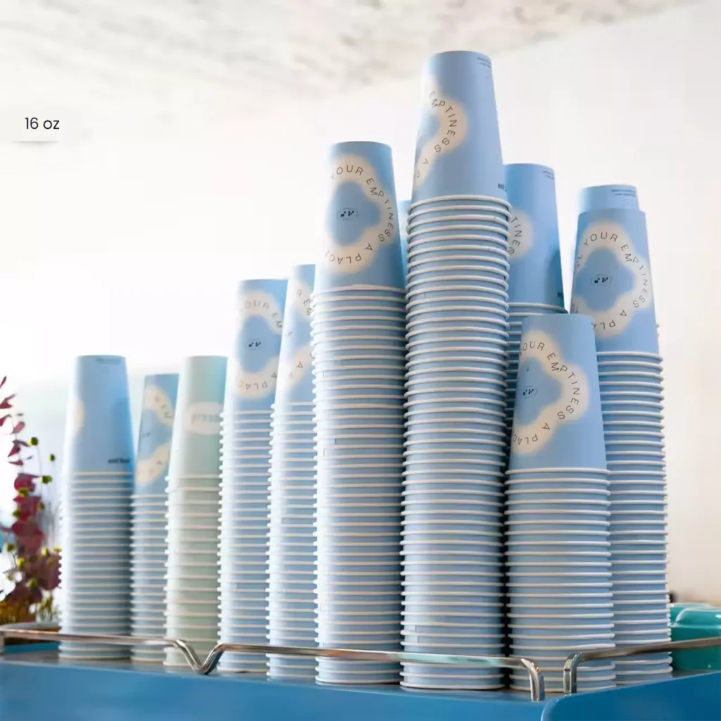 Bulk cup storage of 16 oz custom printed light blue paper coffee cups in stacks