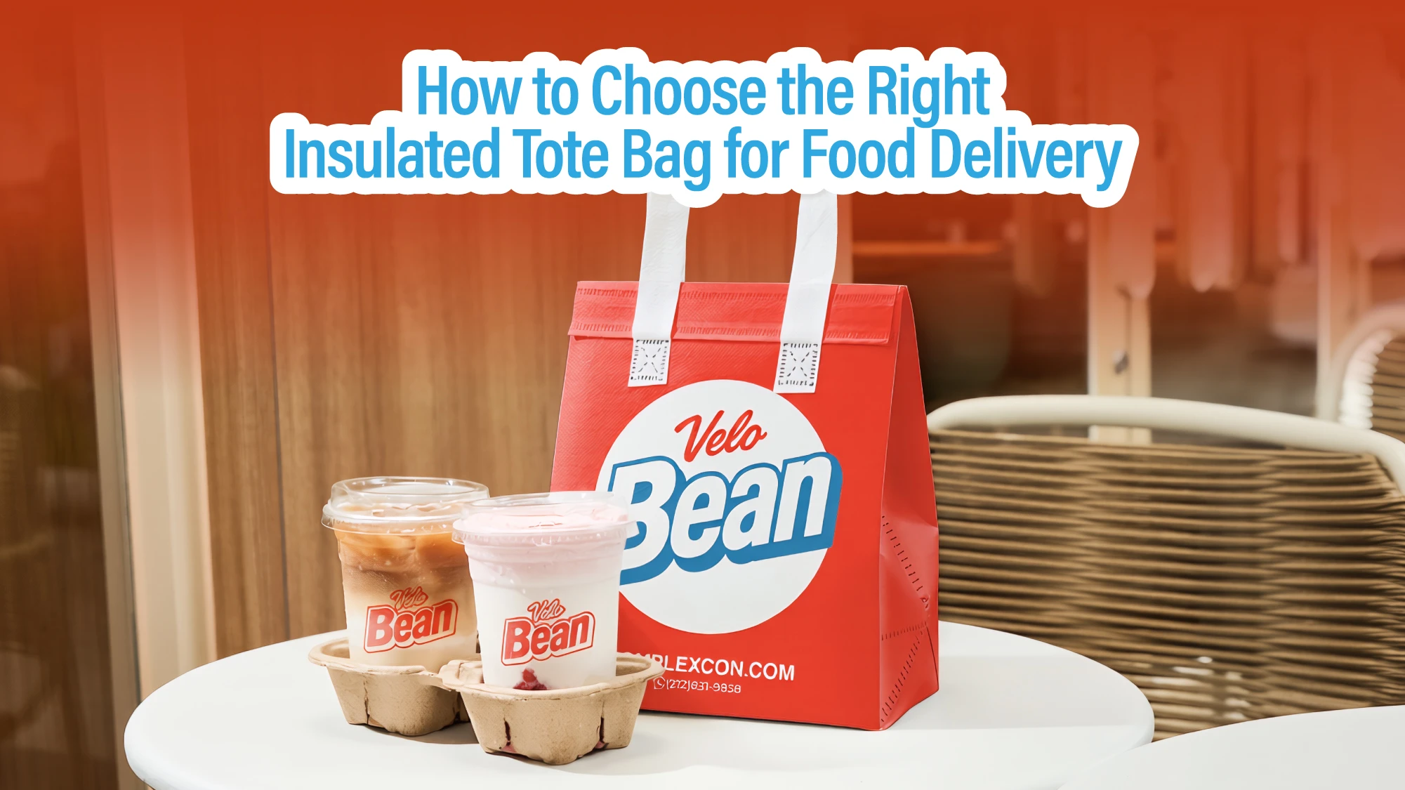 Custom branded red insulated tote bag for food delivery on a cafe table beside two iced coffee cups