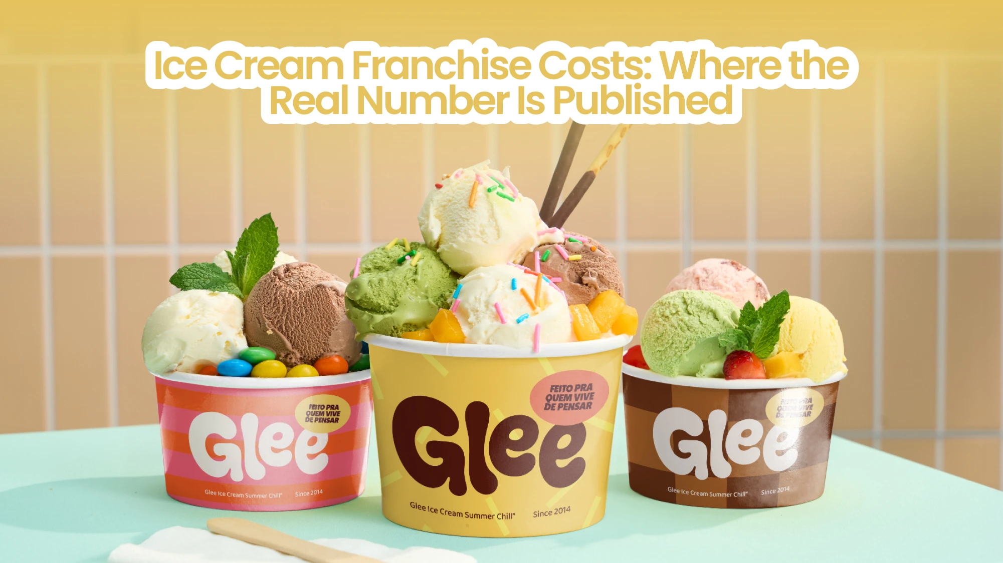 Three branded ice cream cups with assorted scoops and toppings on a counter
